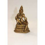 A gilt bronze eastern deity figure