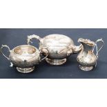A silver plated and engraved three piece tea service