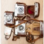 Three cased cameras,