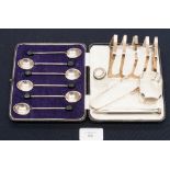 A cased set of six silver coffee spoons; silver toast rack; silver napkin ring; sugar bows;
