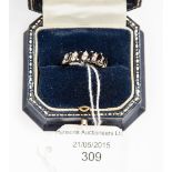 An 18ct white gold, diamond and sapphire half hoop ring, claw set six rows,