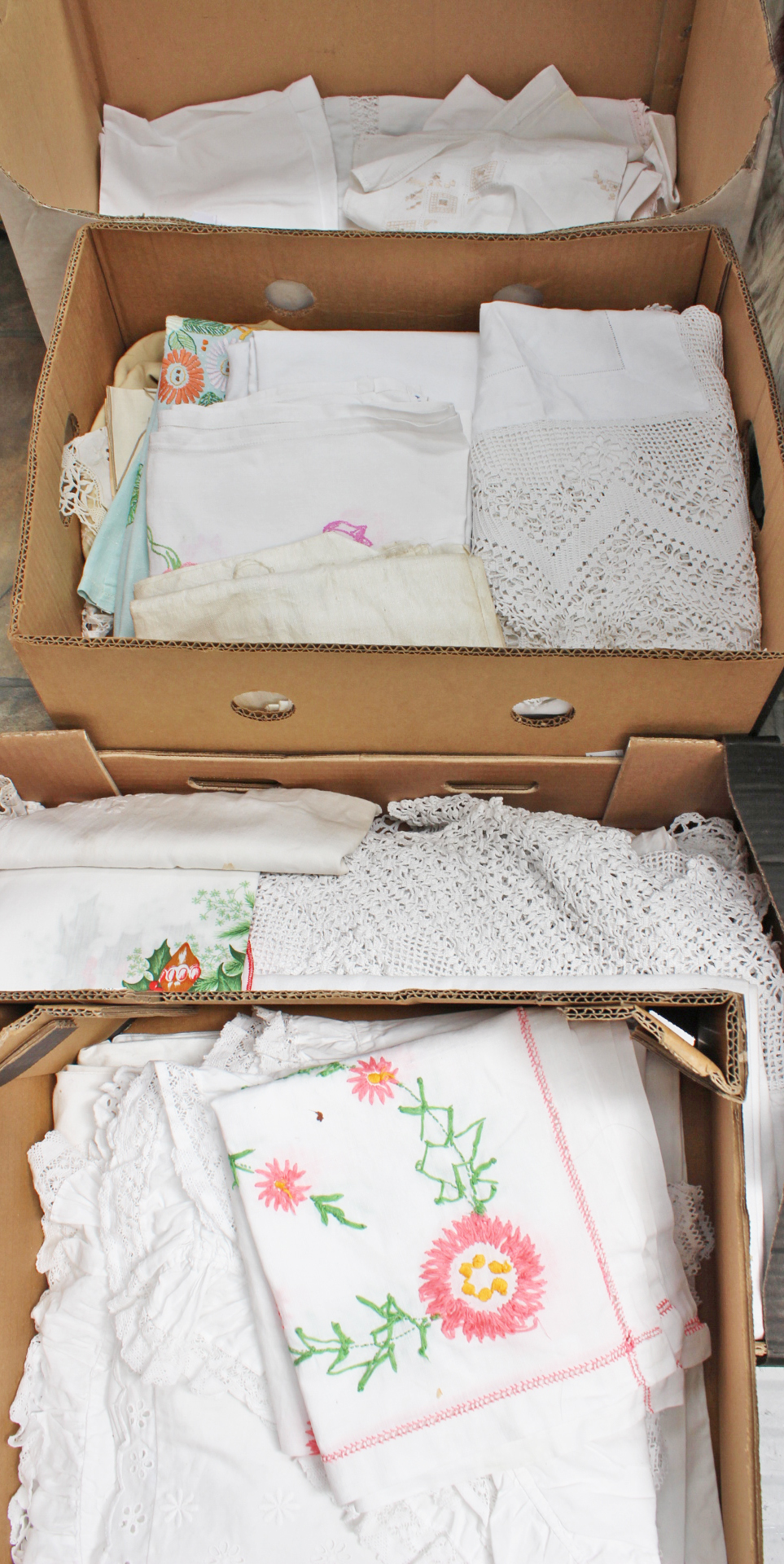 Four boxes of linen including embroidered white work, damask, sheets, towels,