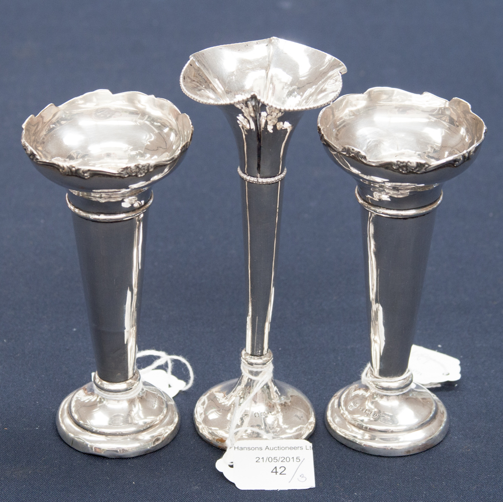 A pair of silver flower vases, 13 cm high approx,