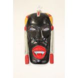 An early 20th Century walnut carved tribal art wall kissing mask.