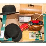 A box of assorted items, including two bowler hats, by Falcon, a cased sewing machine,