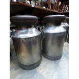 **TO BE SOLD BT PRIVATE TREATY**
A pair of leather upholstered steel milk churns,