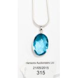 A Blue Topaz pendant necklace, the multi-faceted synthetic stone of approximately 22ct,