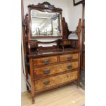 An Edwardian walnut dressing chest with large tilting mirror to back with two winged mirrors to