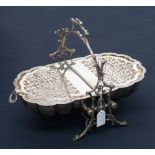 A Victorian silver-plated biscuit box, in the form of a shell, supported in a twig cast frame,