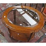 A pair of French style two tier glass topped coffee tables.