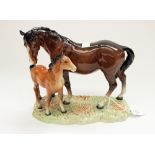 A Beswick Mare and Foal on grassy plinth