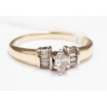 A diamond ring claw set central marquise cut diamond with four baguette cut diamonds to each