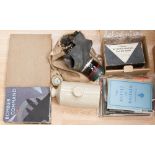 A World War II gas mask in holder, air raid first aid kit, stone flagon,