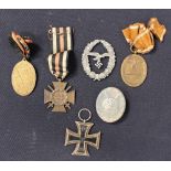 A collection of German World War One and Two medals and badges