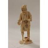 A Japanese carved ivory okimono of a man with a wooden leg,