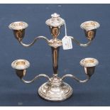 A silver candelabrum, having four branches, a centre candle holder and finial,
