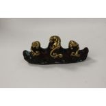 A bronze and brass/gilt metal model of beasts on waves