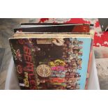 A collection of twenty LP records, including The Beatles,