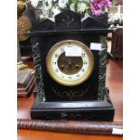 A black marble mantel clock, with Arabic numerals,