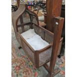 An early 20th century canework crib,