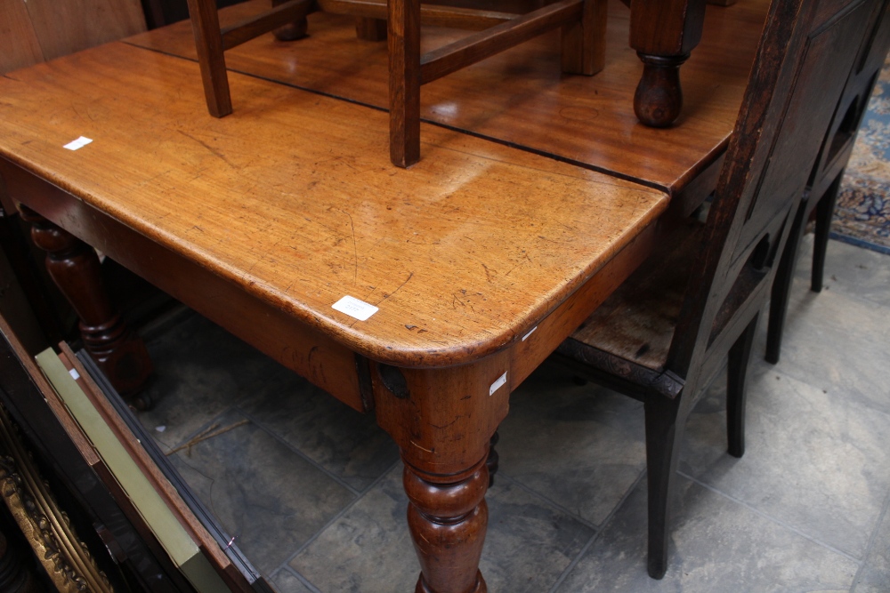 A mid Victorian mahogany wind out extending dining table,