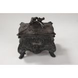 A WMF pewter casket, cast in the Rococo style, the lid with two birds surmounted,
