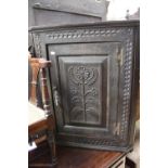 A 19th Century oak ebonised hanging corner cupboard (of pegged mortise and tenon construction)