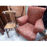 An early 20th Century red upholstered armchair;