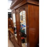 An Edwardian birch wood part bedroom suite, comprising double wardrobe and a three drawer chest.