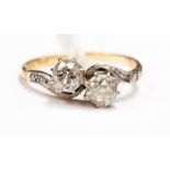 A two stone diamond ring in crossover setting, with two old cut diamonds, each approx 0.