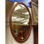 An Edwardian mahogany wall mirror, with parquetry banding,