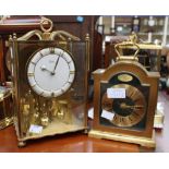 Two brass cased mantle timepieces, one with suspended movement,