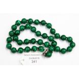 A Malachite single strand bead necklace, with approximately 39 round 10mm beads,