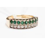 An emerald and diamond ring, having row of nine emeralds above row of brilliant cut diamonds,