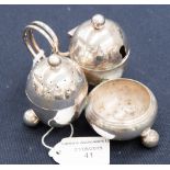 An Edwardian silver cruet set, egg shaped vessels on ball feet,