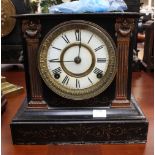 A late 19th Century American black lacquered iron mantle clock with incised gilt decoration and