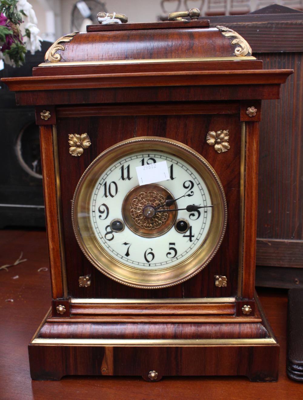 A late 19th Century German rosewood cased eight day mantle clock, with a white enamelled dial,