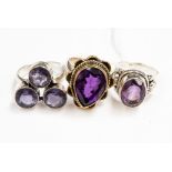 Three silver amethyst ladies dress rings, one set with a cluster of three amethysts,