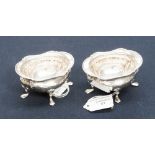 A pair of Edward VII oval shaped salts with raised scroll border,