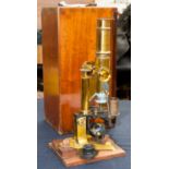 A mahogany cased microscope in brass, with adjustable action,