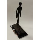 After Giacometti, a bronze figure, striding man,