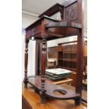 A late Victorian mahogany hall stand fitted with a single drawer, raised on turned supports.