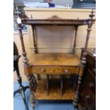 An early Victorian walnut and veneered what not with central drawer