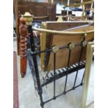 A brass and black painted single bed,