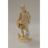 A 19th century Japanese carved ivory figure of a gardener with hoe and vegetables,