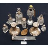 A pair of sterling silver squat candlesticks and assorted scent bottles (11)