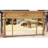 An Empire Revival style gilt framed over mantle mirror,