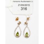 A pair of 9ct gold and peridot drop earrings