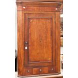 A George III oak two door corner cupboard,