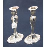 A pair of silver candlesticks,